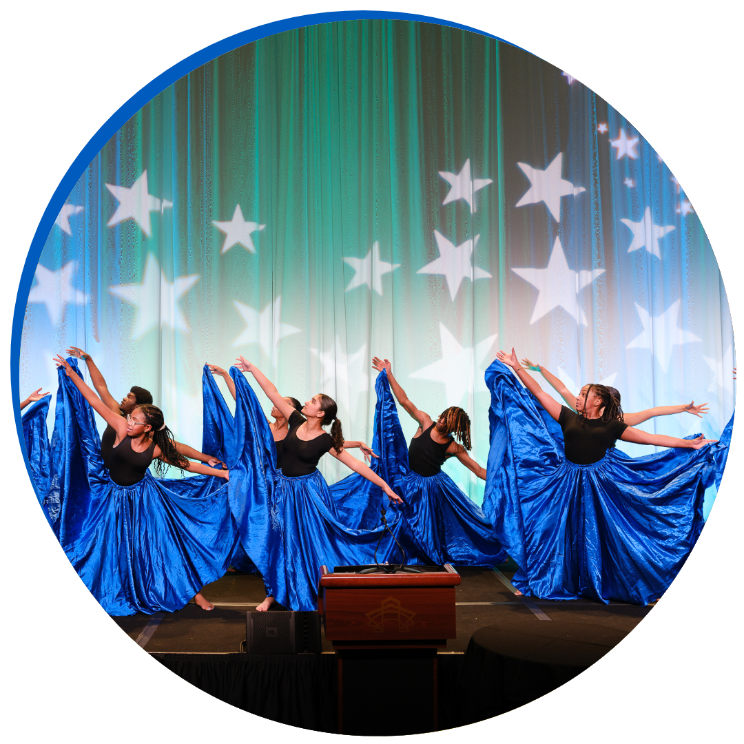 dancers in blue skirts performing at Celebration of Giving
