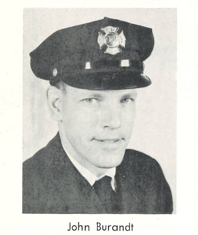 A black and white photograph of a man in a firefighters hat