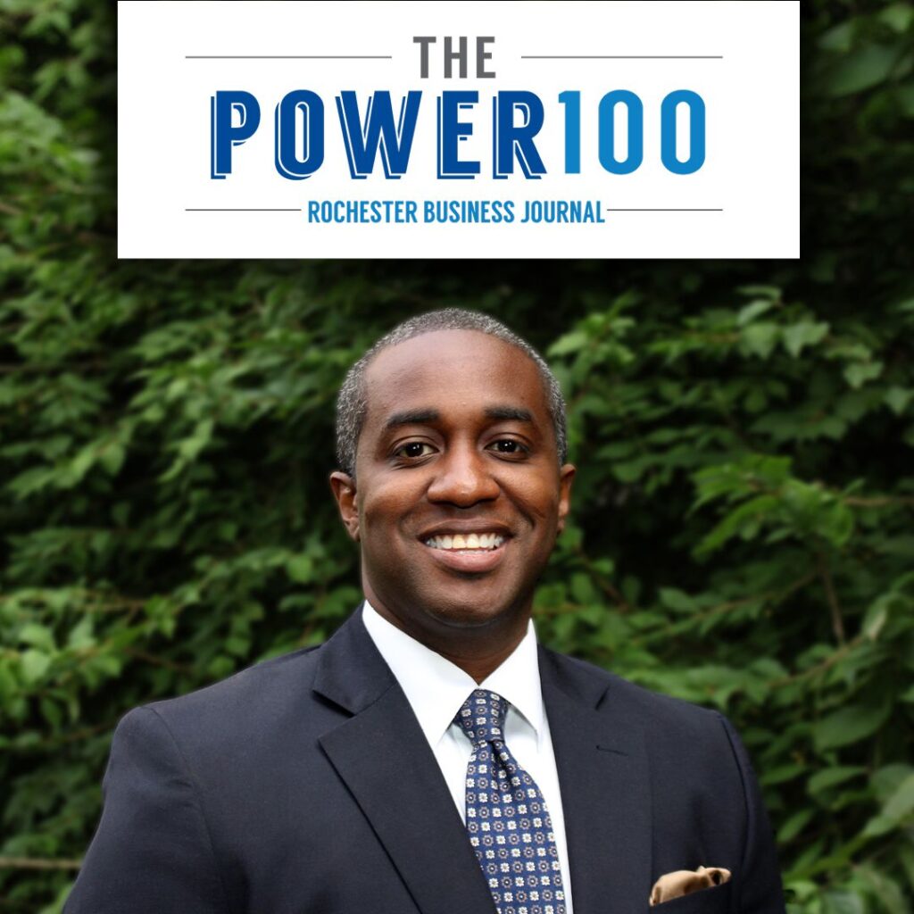The Power 100 (Rochester Business Journal. Simeon Banister in a dark suit and tie, outside.