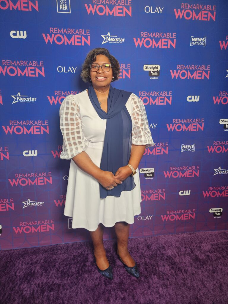 A woman poses at a Remarkable Woman gala