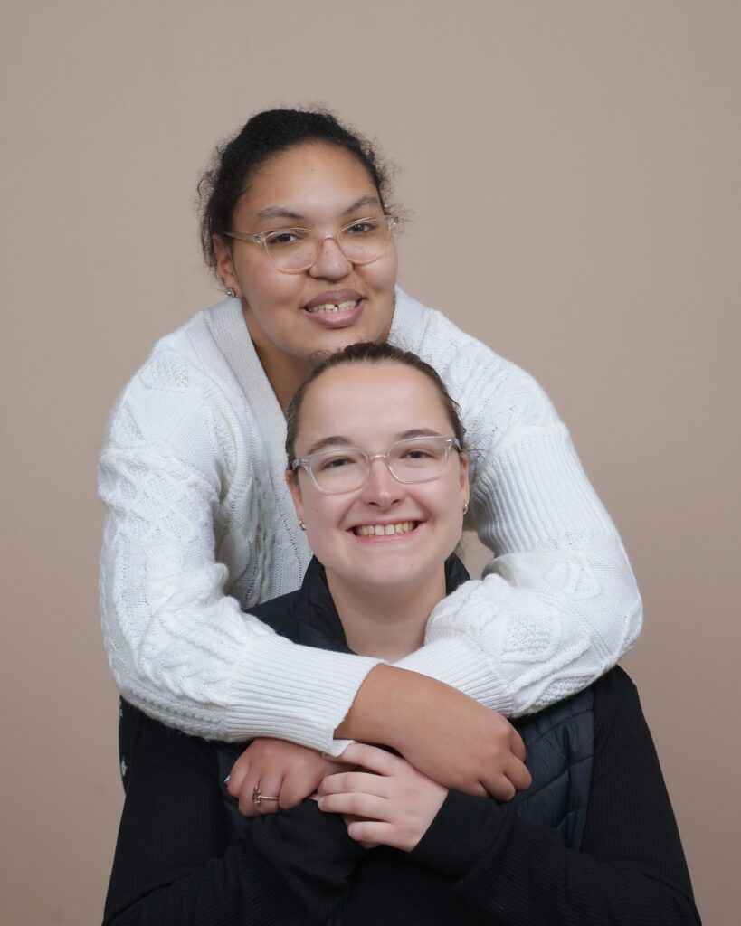 A woman hugging her teenage child