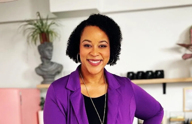 A woman in a purple professional jacket.