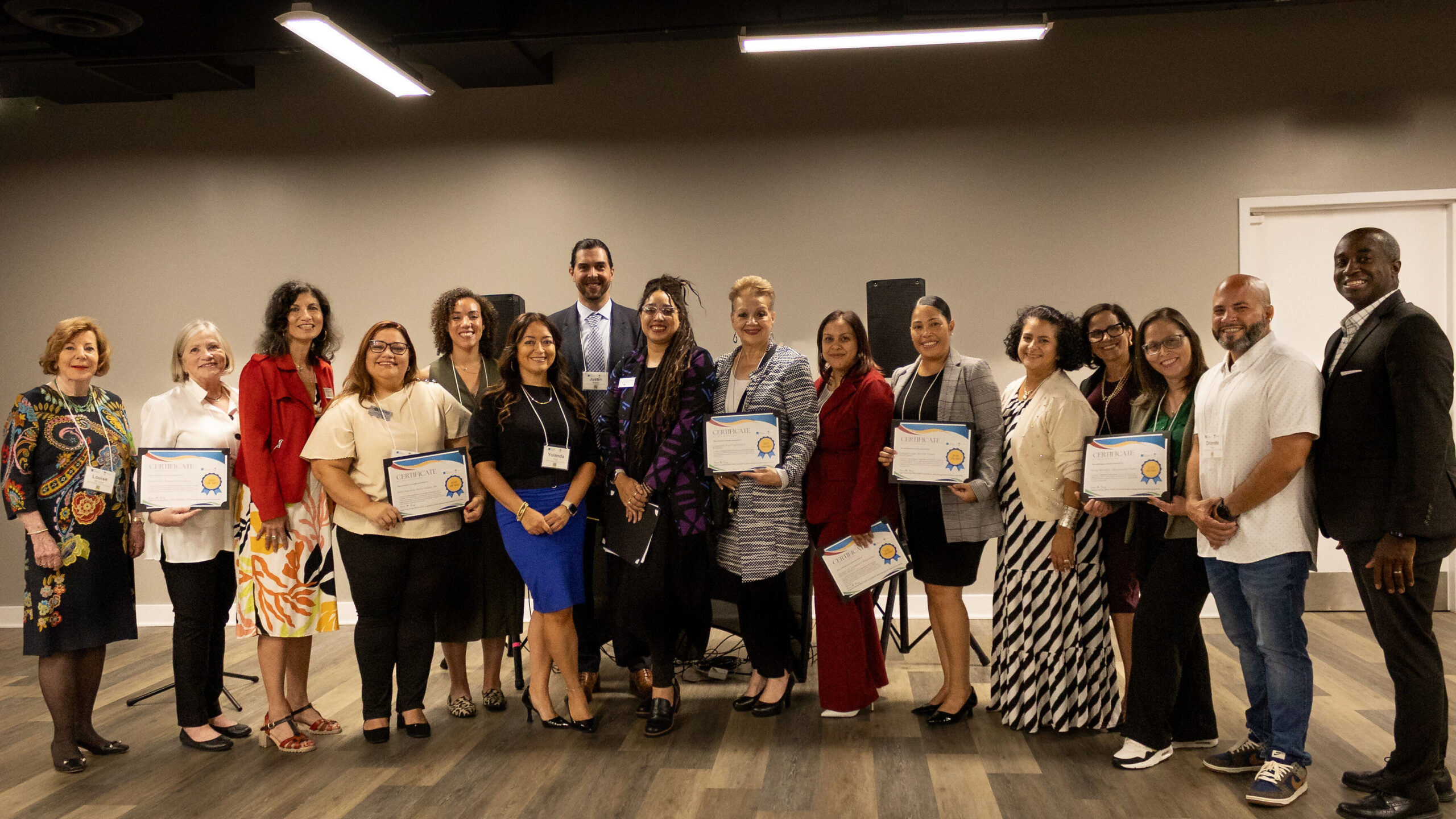 A group of people, several of them holding grant certificates.