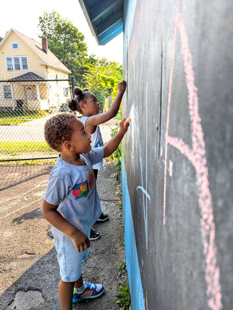 Kids drawing on a chalkboard