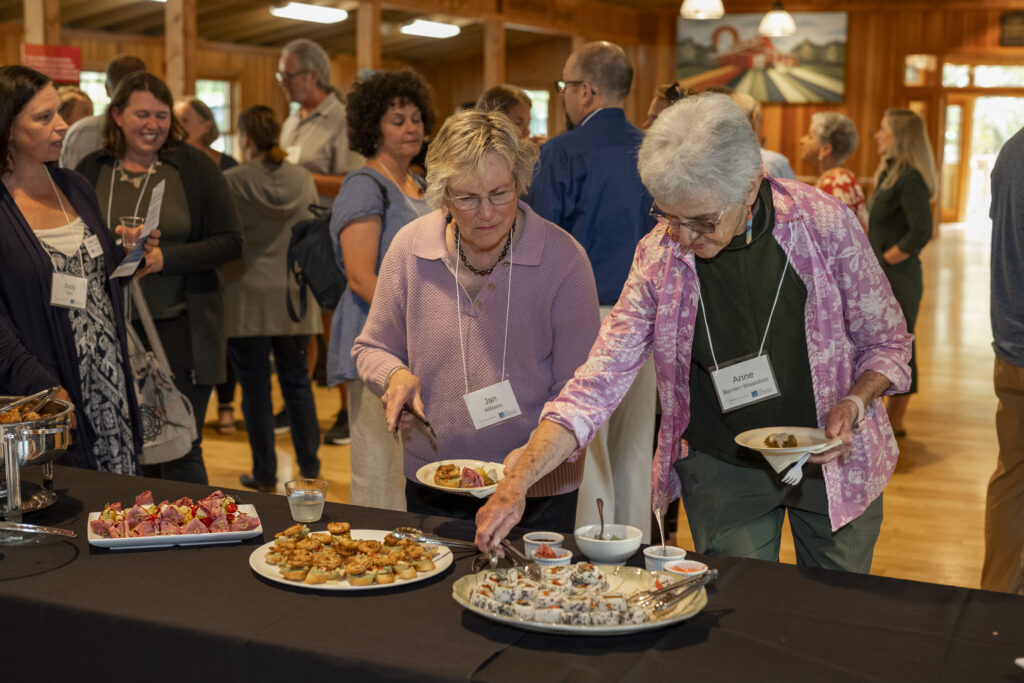two individuals getting food at event