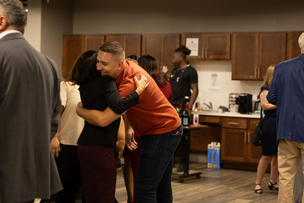 two people hugging at Latino Giving Circle grants reception