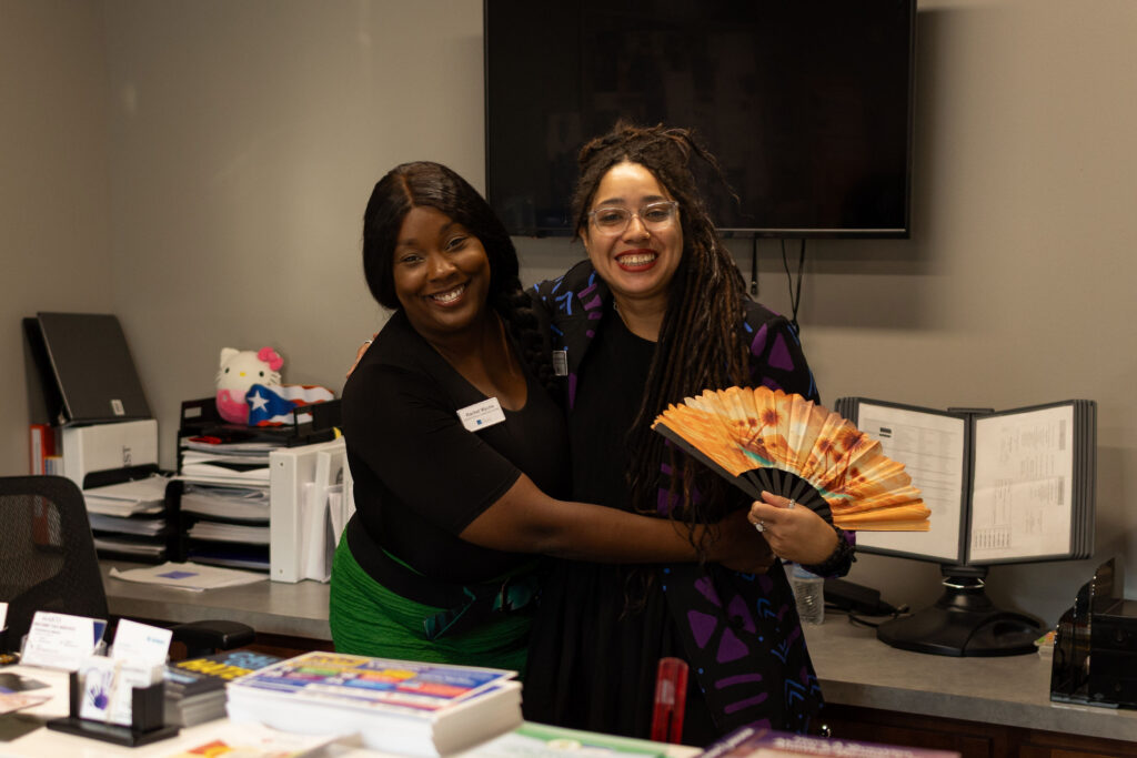 two women hugging at Latino Giving Circle grants reception