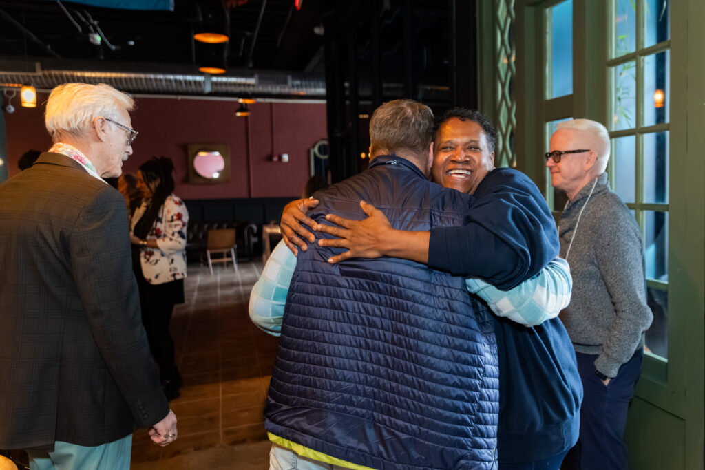 two people hugging at giving circle event