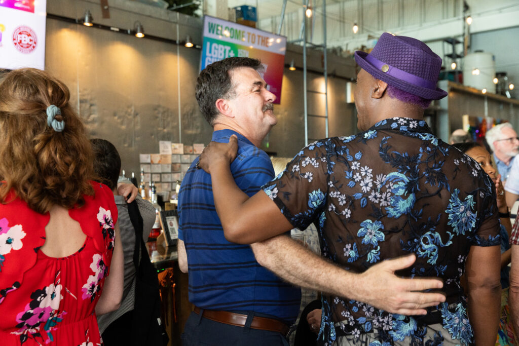 two people embracing at the LGBT+ giving circle event