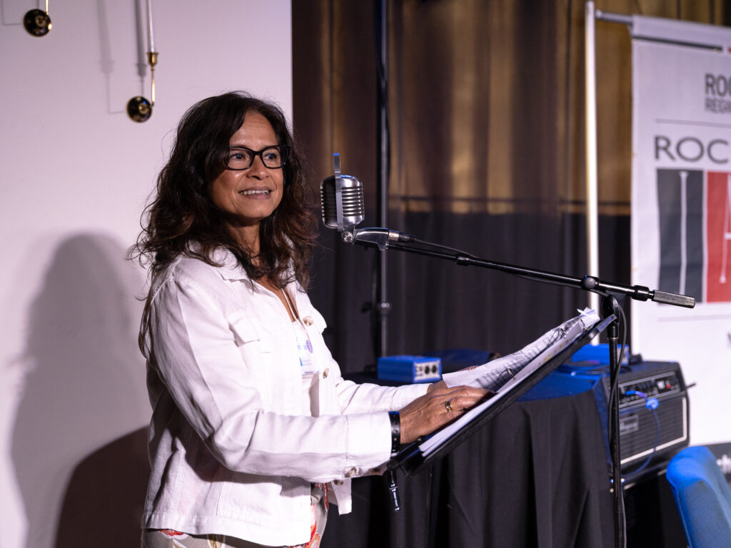 Patricia speaking at evening out with jazz