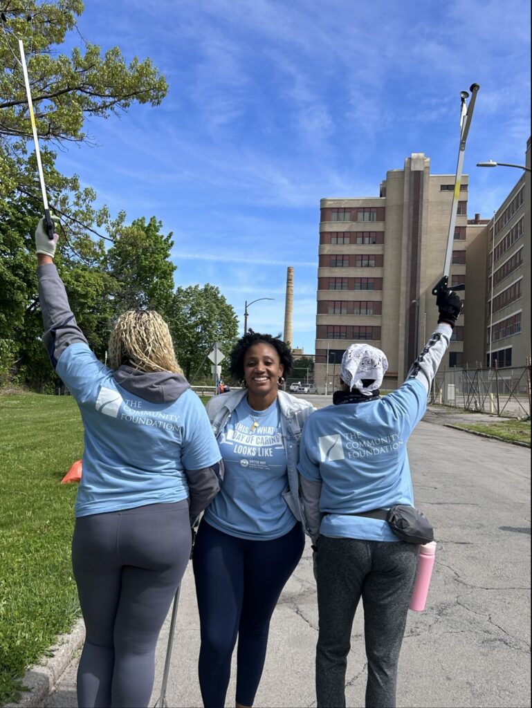 three people posing for Day of Caring with Community Foundation shirts